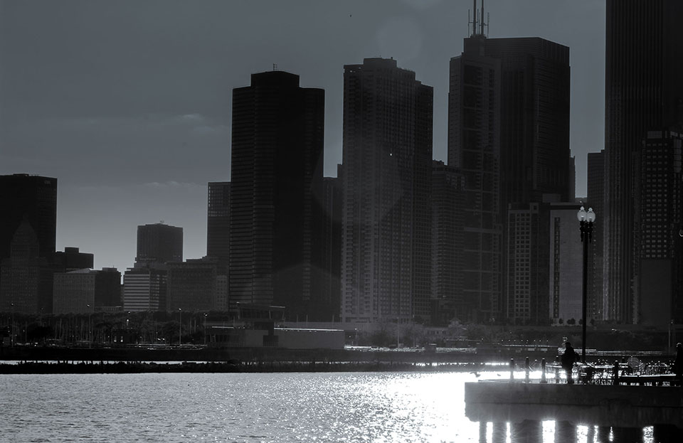 black and white photo of several apartment high-rises in along the shoreline of Chicago - taken from Chicago Pier.